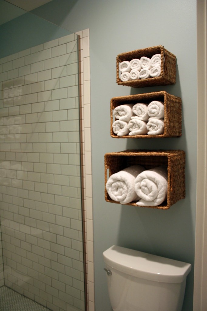 Baskets against the wall are used as storage space for towels